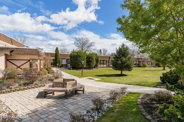 a view of a house with backyard sitting area and garden
