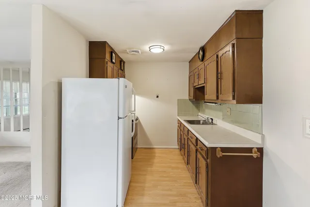 a kitchen with a sink and a refrigerator