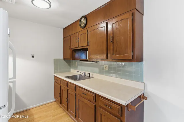 a kitchen with stainless steel appliances granite countertop a sink and dishwasher with wooden cabinets