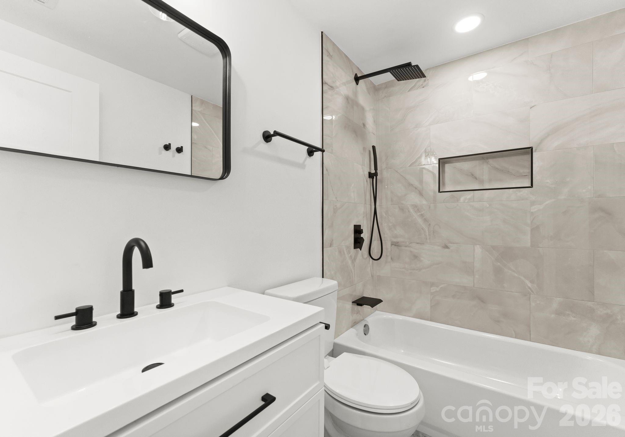 1413 Modena Street Gastonia, NC 28054 - Photo 15 of 27 a bathroom with a sink toilet and shower