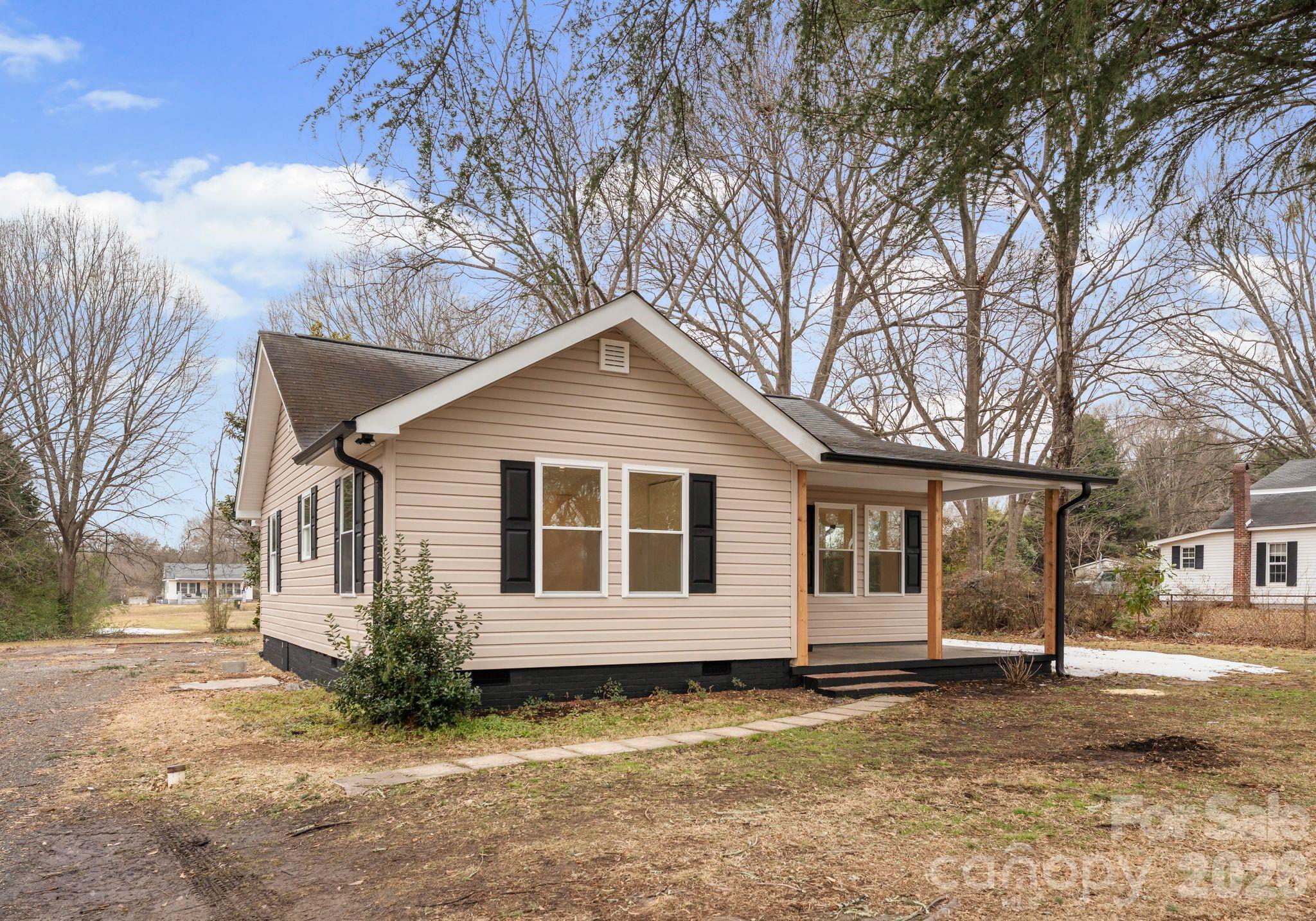 1413 Modena Street Gastonia, NC 28054 - Photo 3 of 27 a view of a yard with a house and a tree