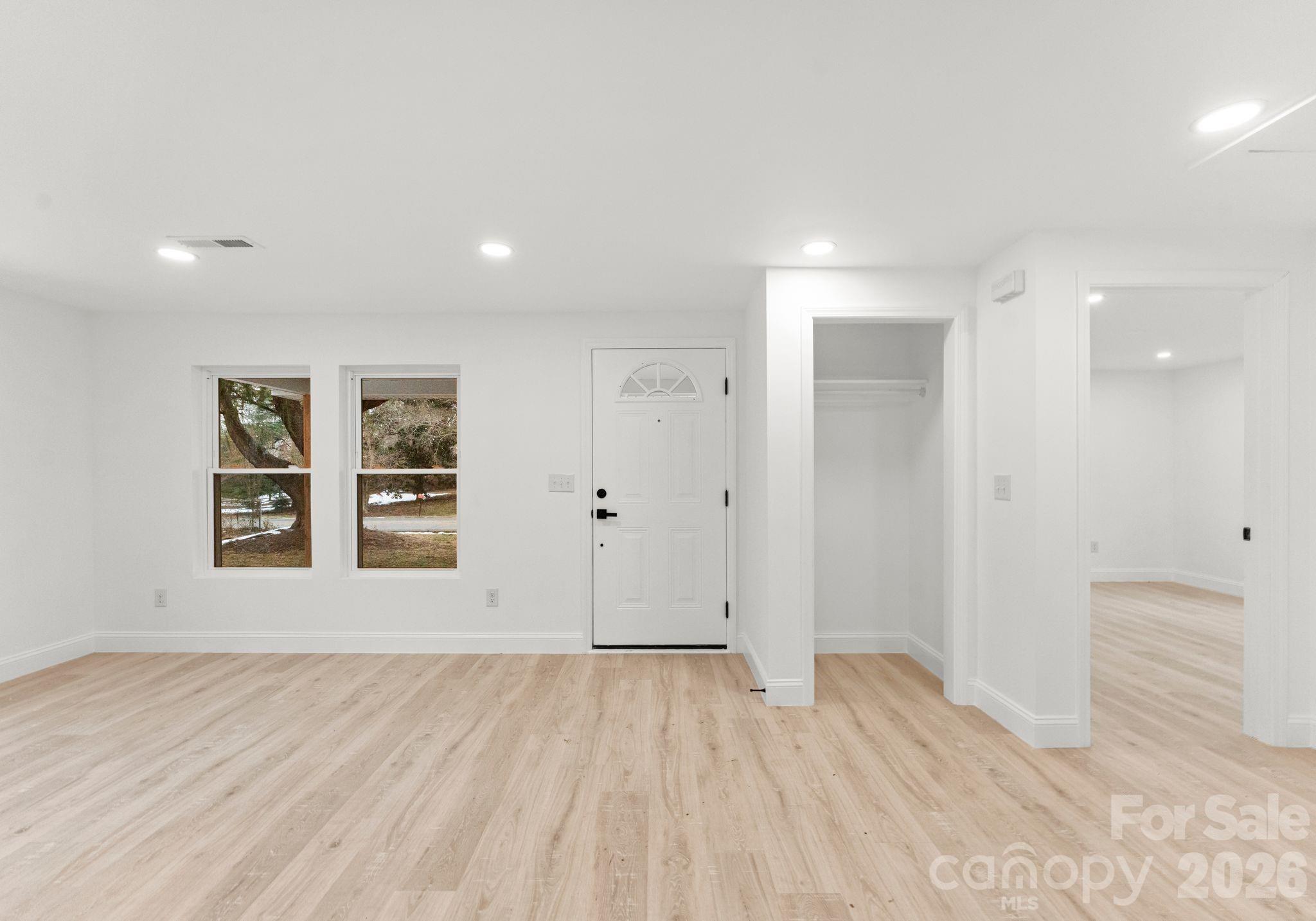1413 Modena Street Gastonia, NC 28054 - Photo 7 of 27 a view of an empty room with wooden floor and a window