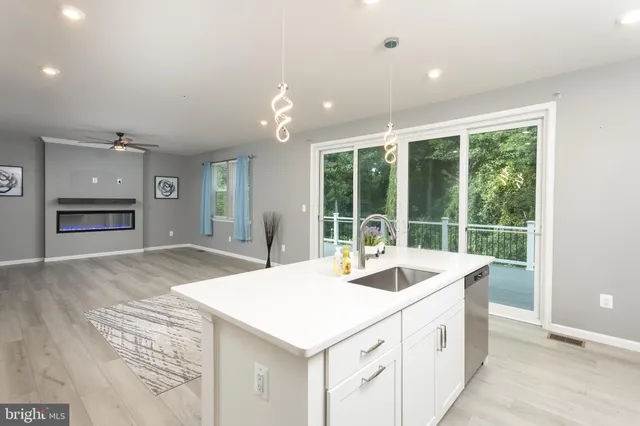 a kitchen with sink and large windows