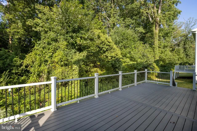 a view of a balcony with wooden floor and fence