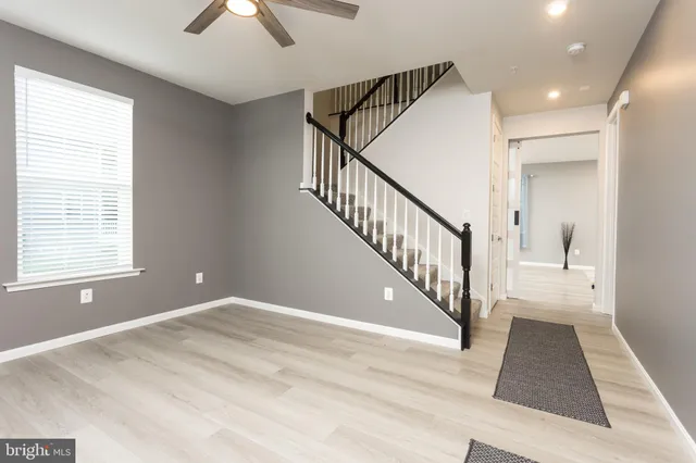 a view of entryway and hall with wooden floor