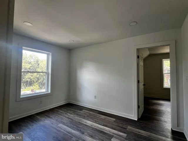 a view of a room with wooden floors and window