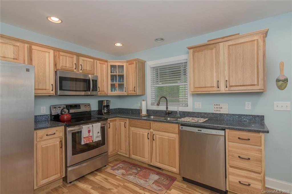 2500 Catawba River Road Old Fort, NC 28762 - Photo 2 of 24 a kitchen with stainless steel appliances granite countertop a sink stove and microwave