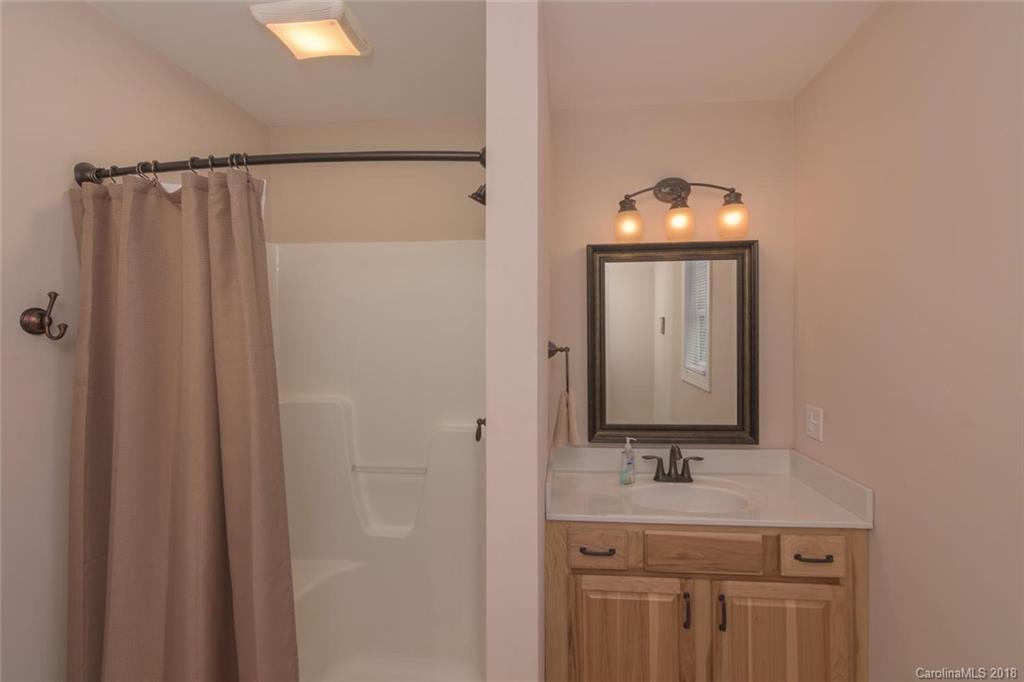 2500 Catawba River Road Old Fort, NC 28762 - Photo 17 of 24 a bathroom with a mirror sink and vanity