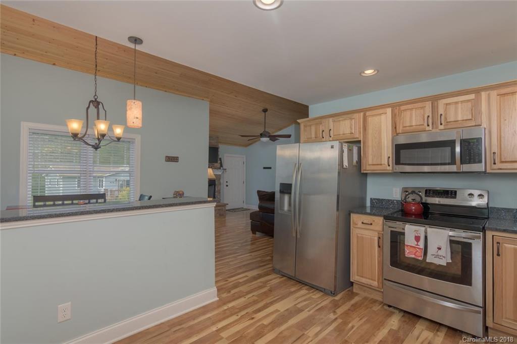 2500 Catawba River Road Old Fort, NC 28762 - Photo 4 of 24 a kitchen with stainless steel appliances granite countertop a refrigerator a stove a sink and a microwave