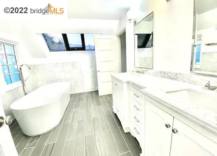 515 Hampton Road Piedmont, CA 94611 - Photo 11 of 13 a spacious bathroom with a sink and a mirror