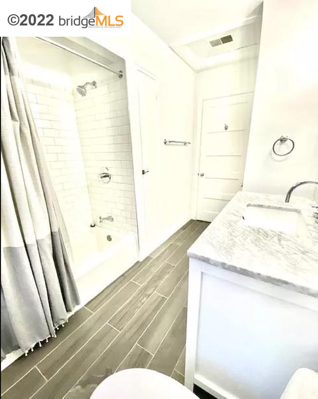 515 Hampton Road Piedmont, CA 94611 - Photo 9 of 13 a bathroom with a granite countertop sink a mirror and a shower