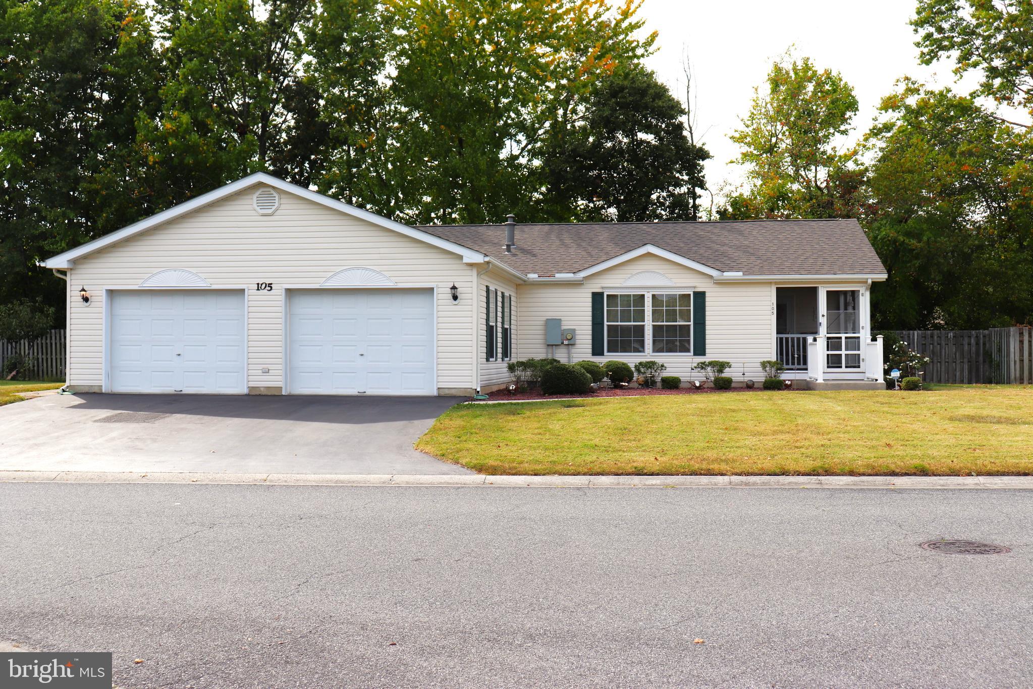 105 Kurt Drive Dover, DE 19901 - Photo 1 of 1 a front view of a house with a yard and trees all around