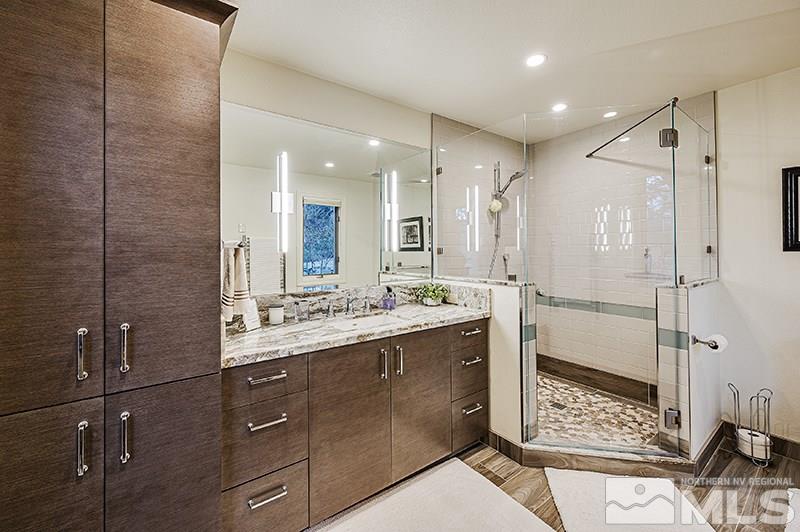 4278 Bitteroot Road Reno, NV 89519 - Photo 21 of 29 a bathroom with a glass door shower a sink and a mirror
