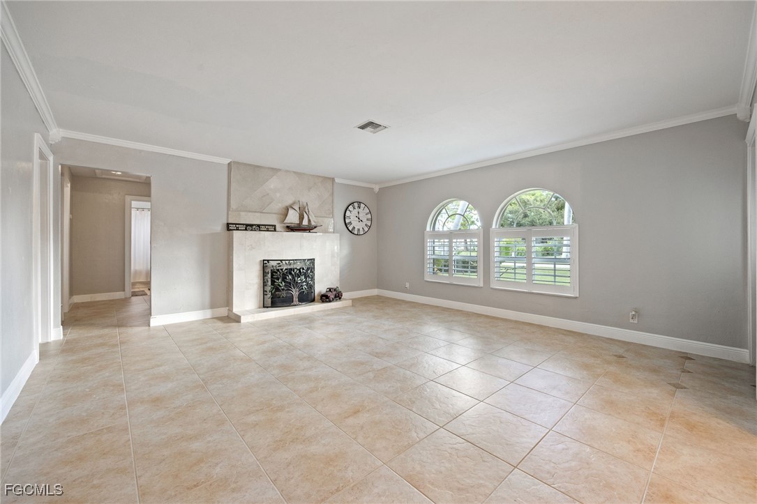 8327 Riviera Avenue Fort Myers, FL 33919 - Photo 12 of 49 an empty room with windows and fireplace
