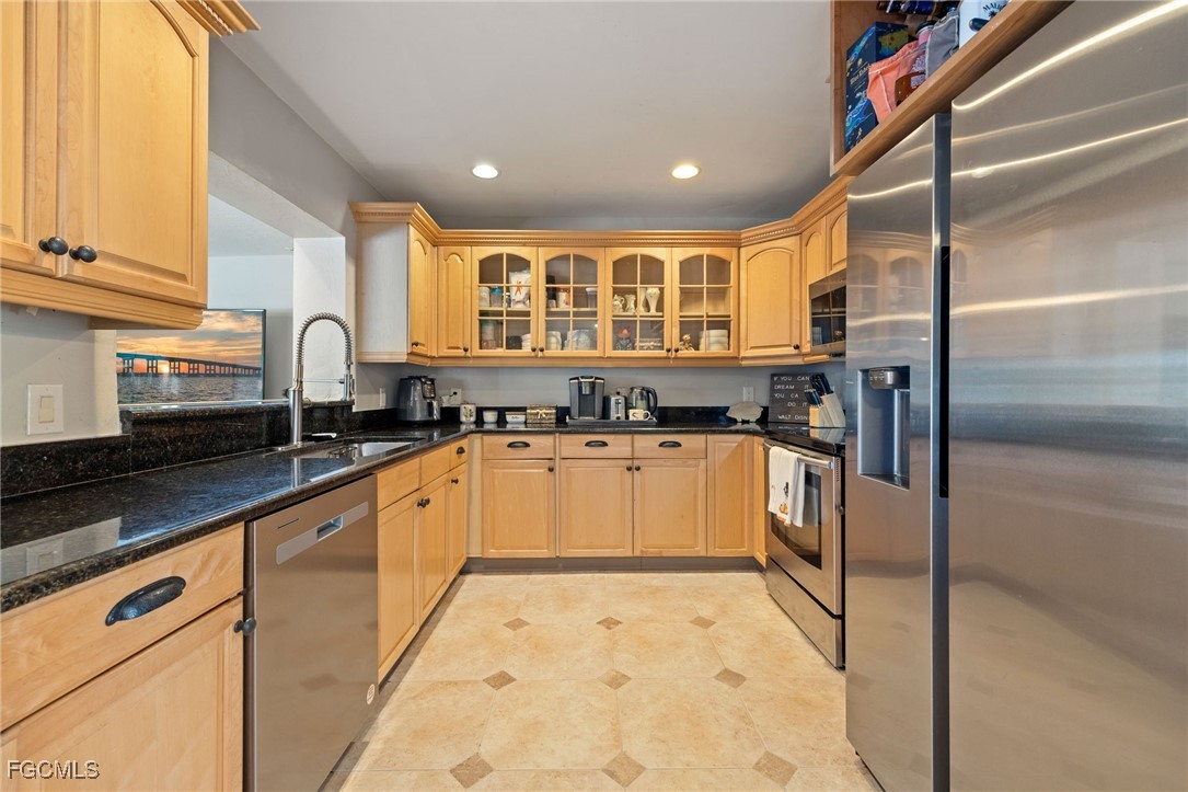 8327 Riviera Avenue Fort Myers, FL 33919 - Photo 16 of 49 a kitchen with granite countertop white cabinets and white appliances