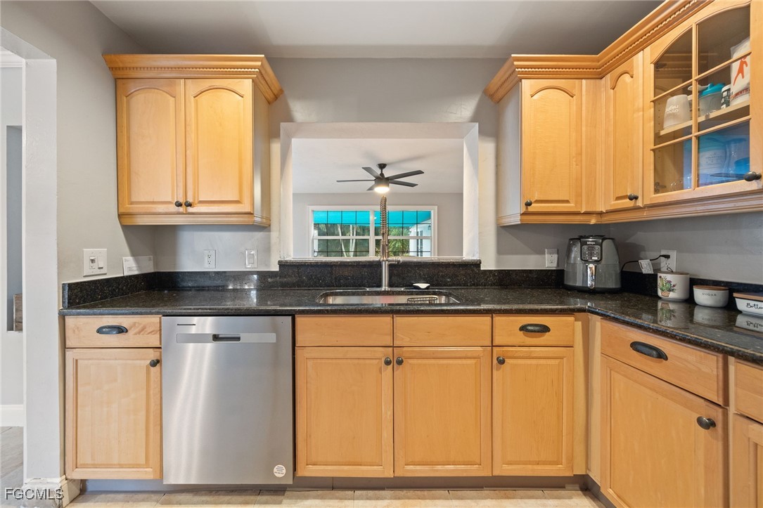 8327 Riviera Avenue Fort Myers, FL 33919 - Photo 17 of 49 a kitchen with stainless steel appliances granite countertop a sink and cabinets