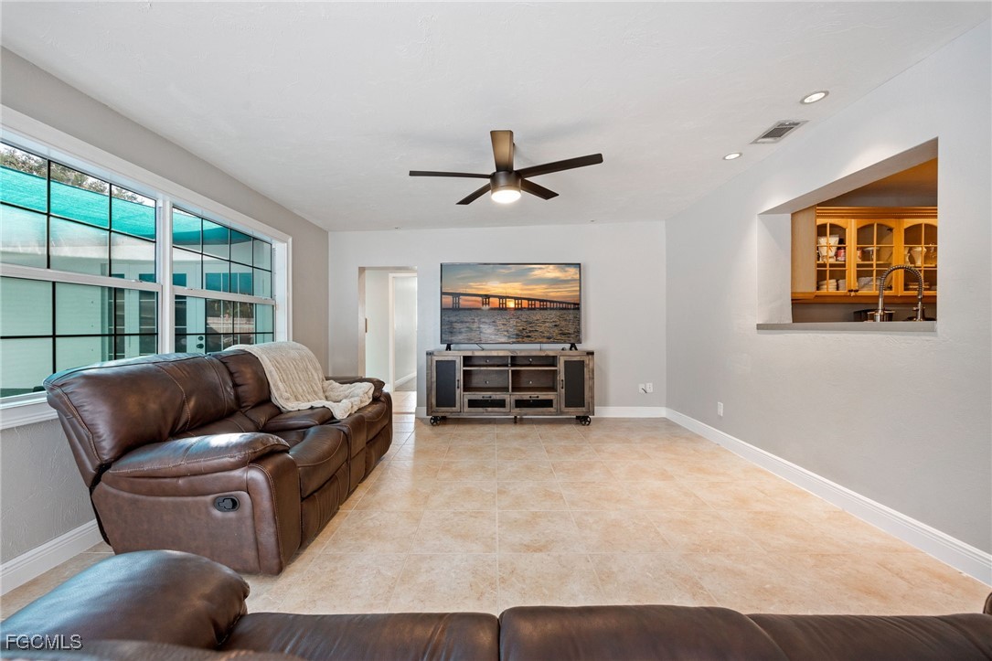 8327 Riviera Avenue Fort Myers, FL 33919 - Photo 21 of 49 a living room with furniture a ceiling fan and a window