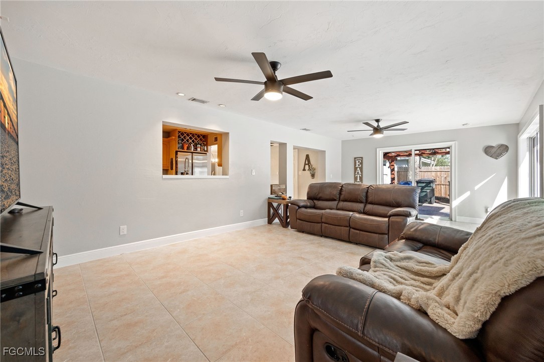 8327 Riviera Avenue Fort Myers, FL 33919 - Photo 22 of 49 a living room with furniture and a ceiling fan
