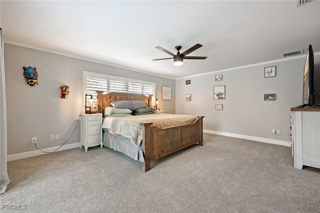 8327 Riviera Avenue Fort Myers, FL 33919 - Photo 26 of 49 a bedroom with a bed and a large window