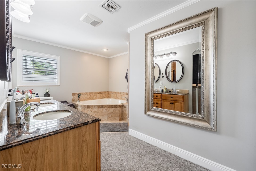 8327 Riviera Avenue Fort Myers, FL 33919 - Photo 29 of 49 a bathroom with a granite countertop sink vanity and mirror