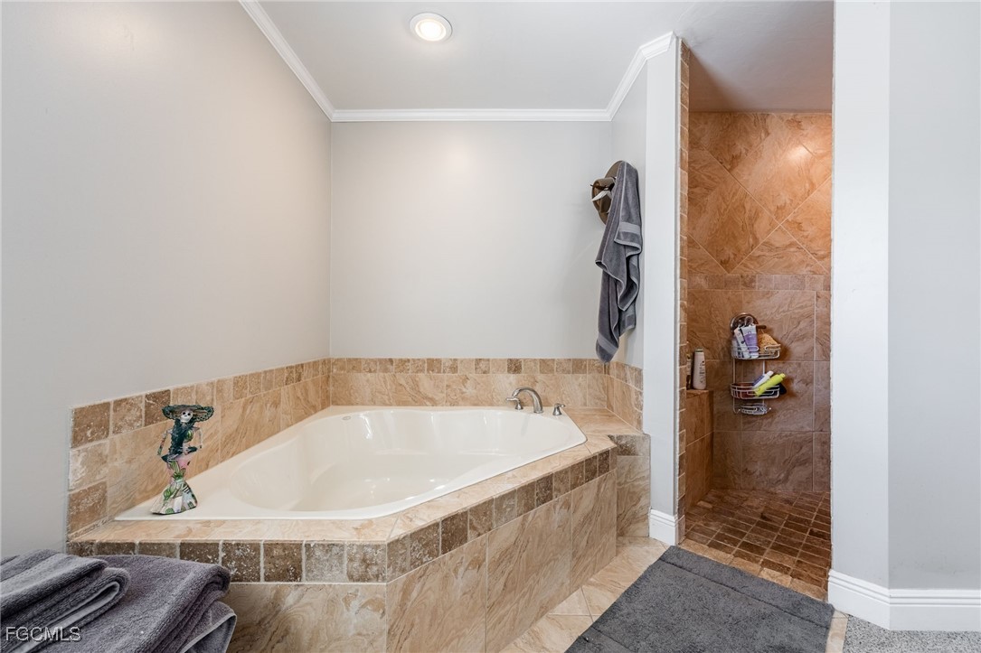 8327 Riviera Avenue Fort Myers, FL 33919 - Photo 30 of 49 a bathroom with a tub and shower