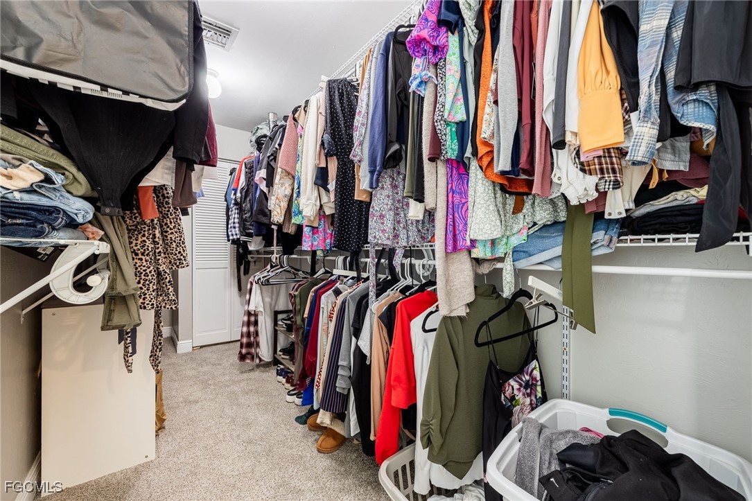 8327 Riviera Avenue Fort Myers, FL 33919 - Photo 31 of 49 a view of walk in closet with clothes and shoes