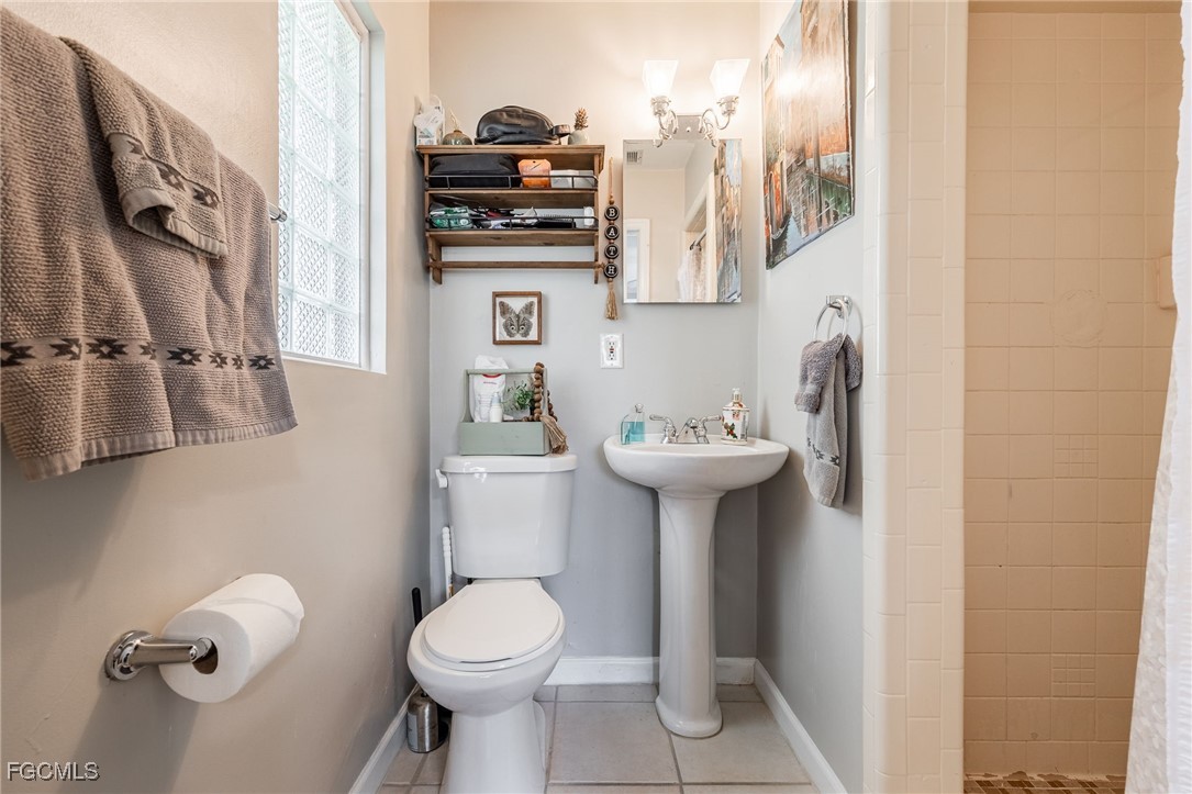 8327 Riviera Avenue Fort Myers, FL 33919 - Photo 33 of 49 a bathroom with a sink toilet and mirror