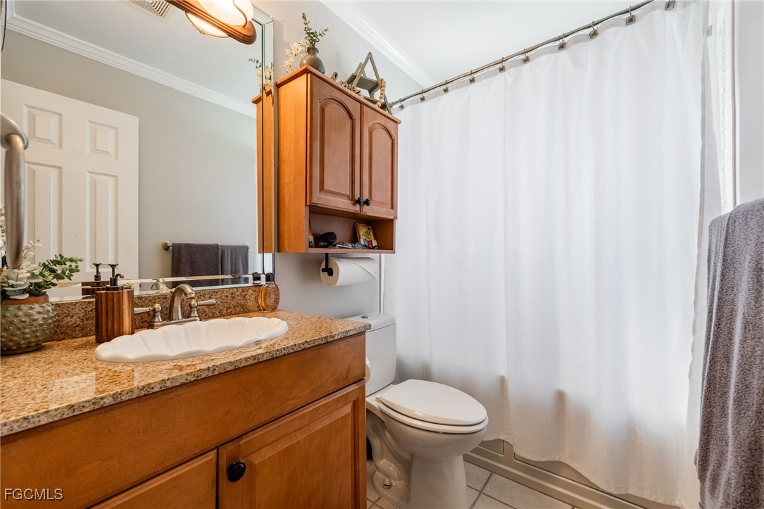 8327 Riviera Avenue Fort Myers, FL 33919 - Photo 35 of 49 a bathroom with a granite countertop sink mirror vanity and toilet