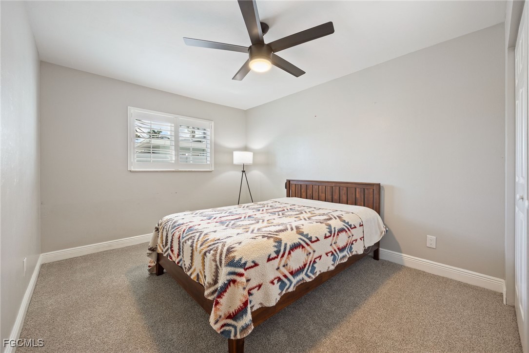 8327 Riviera Avenue Fort Myers, FL 33919 - Photo 36 of 49 a bed sitting in a bedroom next to a window