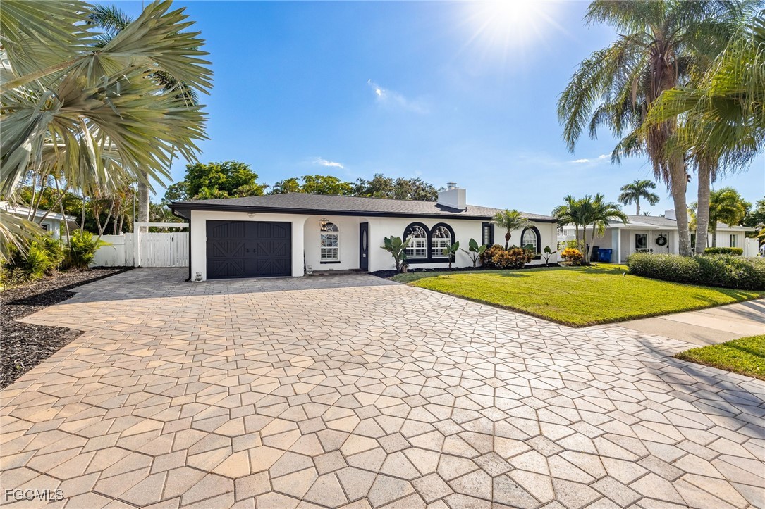 8327 Riviera Avenue Fort Myers, FL 33919 - Photo 5 of 49 a view of swimming pool with lounge chair and palm trees