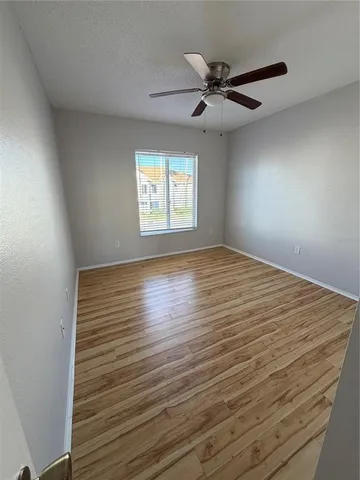 a view of room with window and ceiling fan