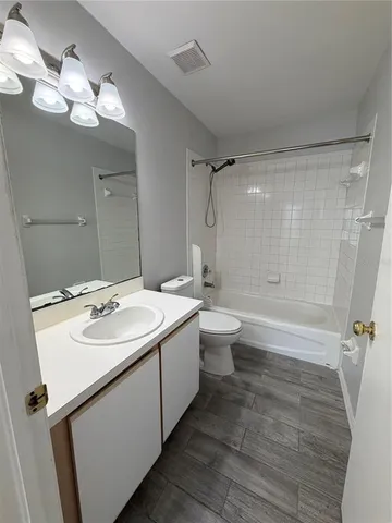 a bathroom with a double vanity sink mirror and toilet