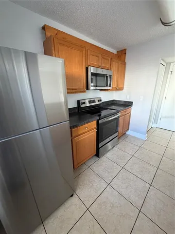a kitchen with stainless steel appliances granite countertop a refrigerator stove and sink