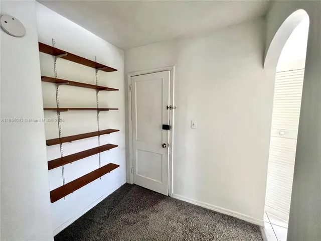 a view of a room with a white walls