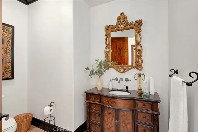 a spacious bedroom with a bed a couch and a painting on the wall