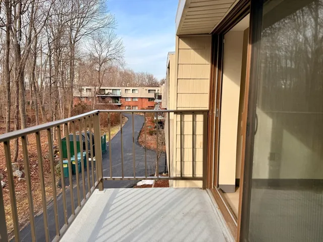 a view of balcony with wooden floor and fence