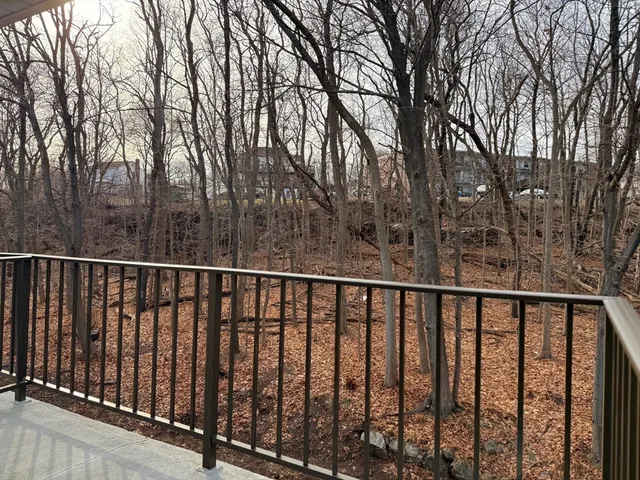 a balcony with wooden fence and trees