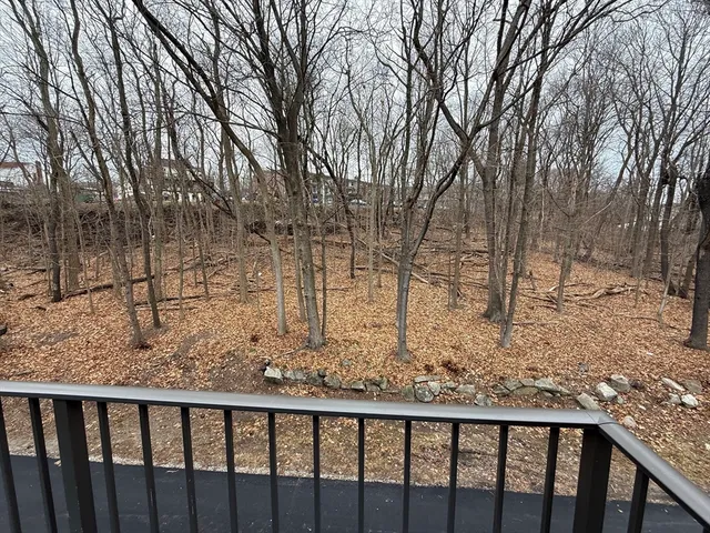 a view of a yard with wooden fence
