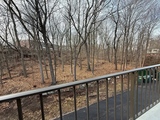 a view of a balcony with wooden fence and floor