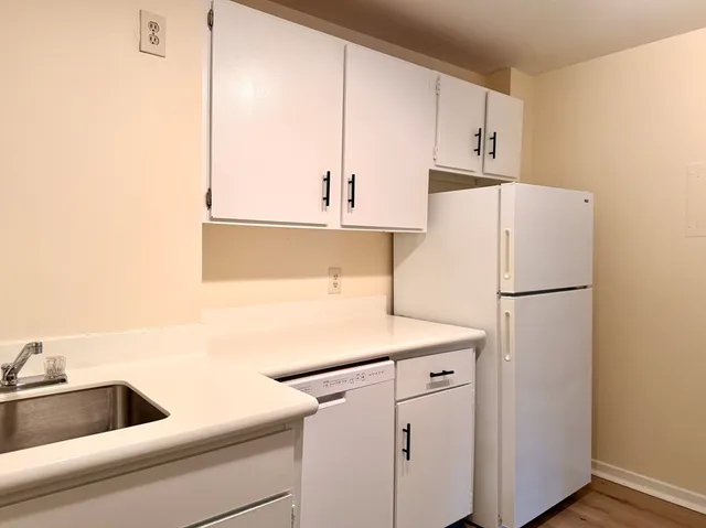 a white refrigerator freezer sitting inside of a kitchen