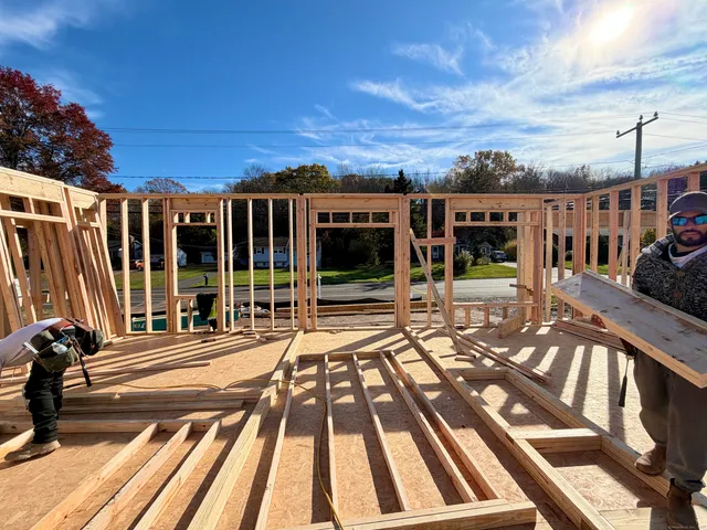 a view of a patio with chairs and large trees