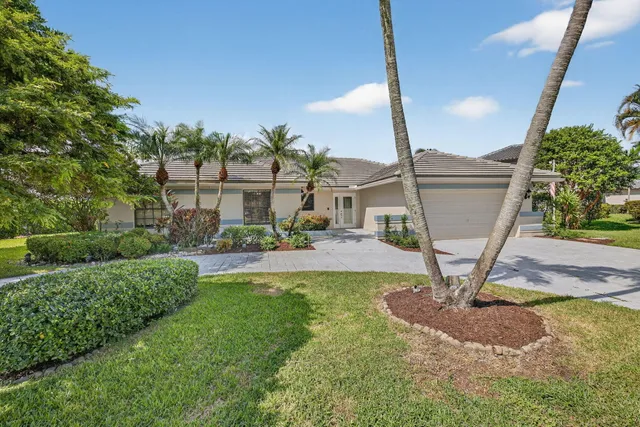 a view of a house with backyard porch and sitting area