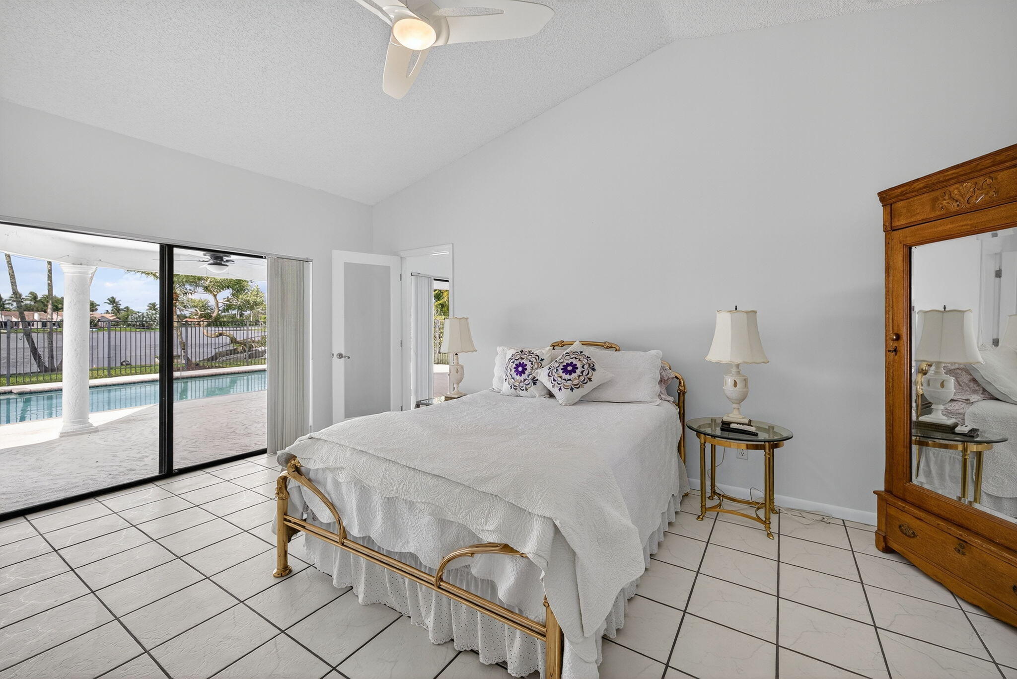 3140 Old Orchard Road Davie, FL 33328 - Photo 20 of 41 a bedroom with a bed and a large mirror next to a window