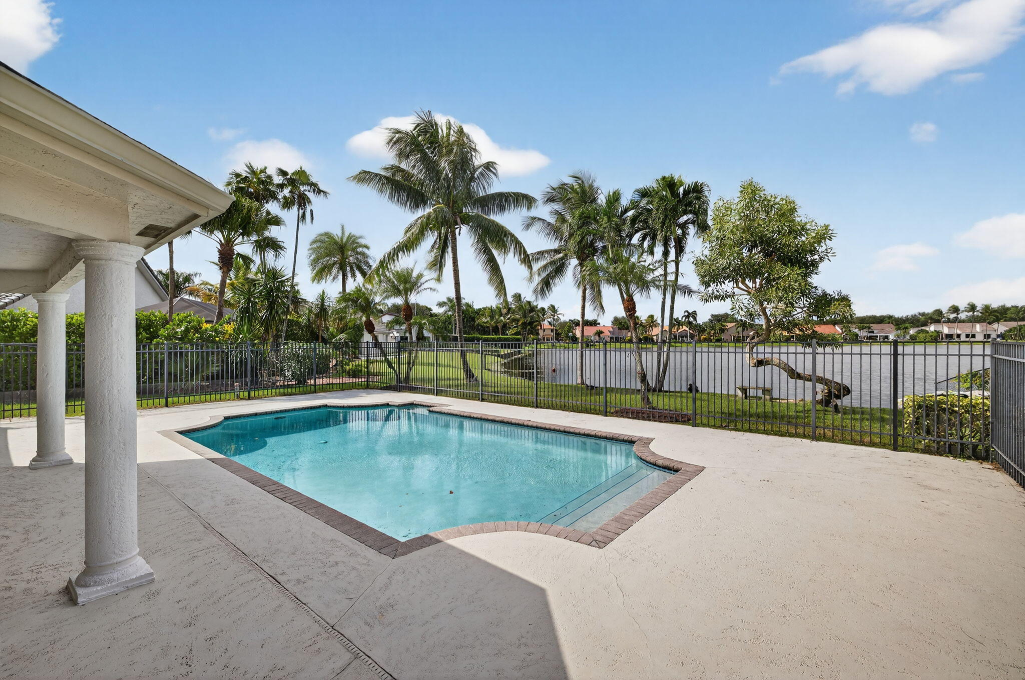 3140 Old Orchard Road Davie, FL 33328 - Photo 31 of 41 a view of a swimming pool with a yard and palm trees