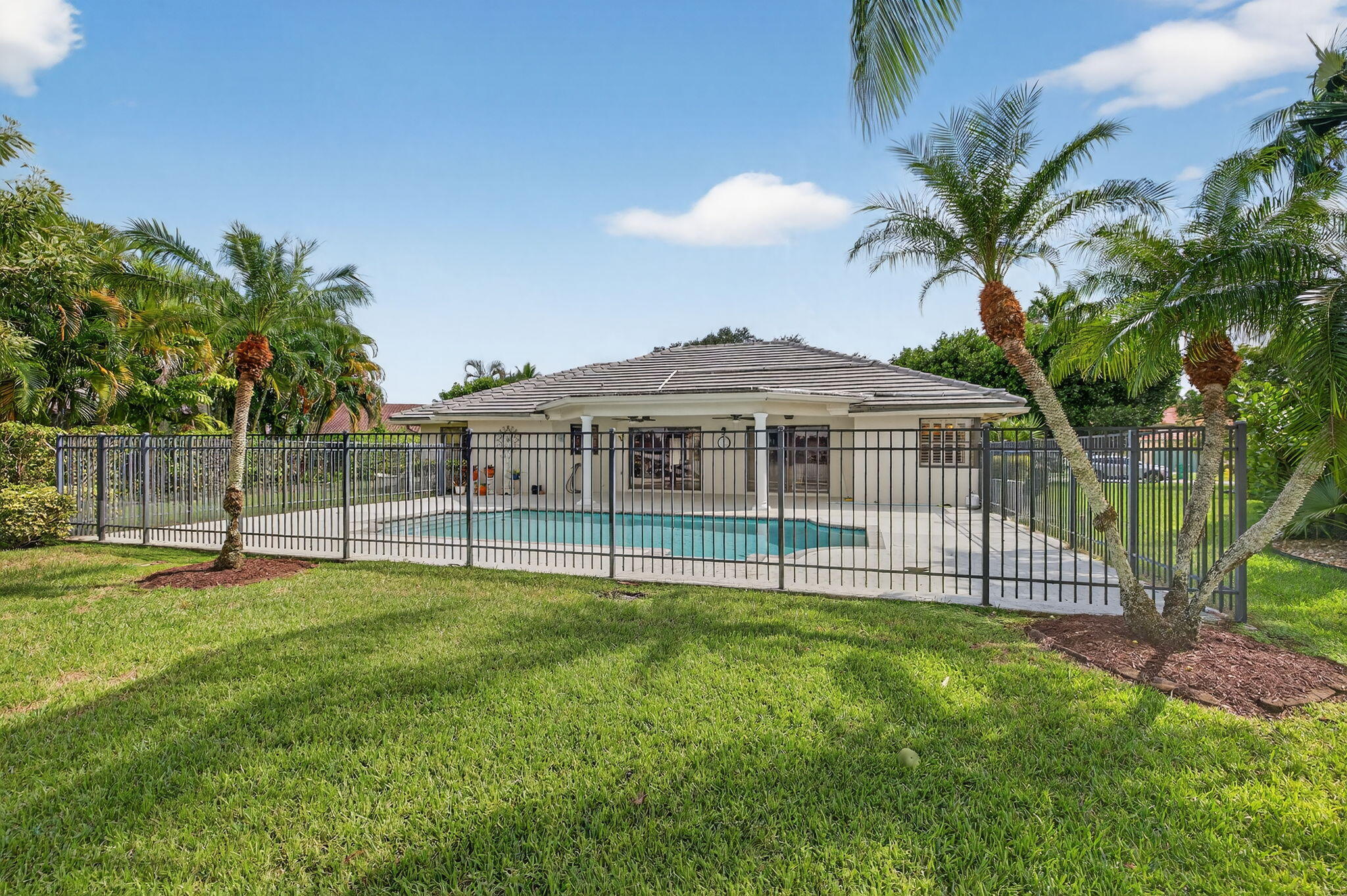 3140 Old Orchard Road Davie, FL 33328 - Photo 36 of 41 a view of outdoor space with a garden and swimming pool
