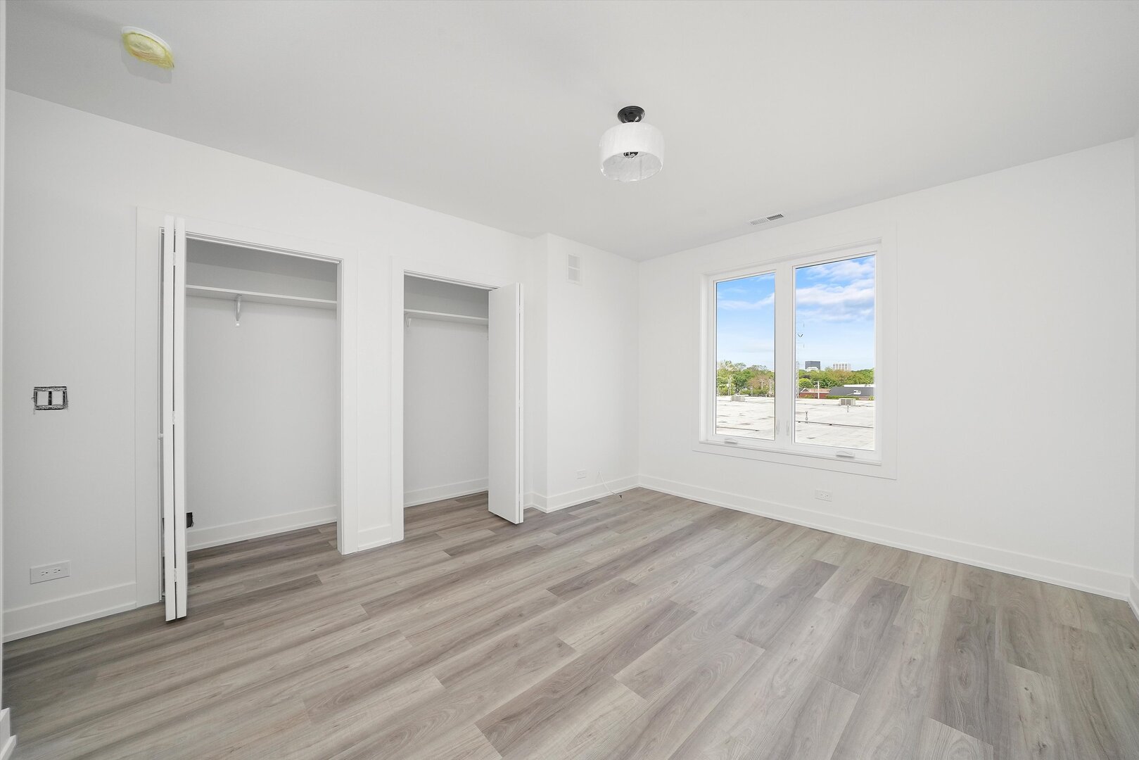 2030 Greenwood Street, Unit 206 Evanston, IL 60201 - Photo 16 of 27 an empty room with wooden floor and windows
