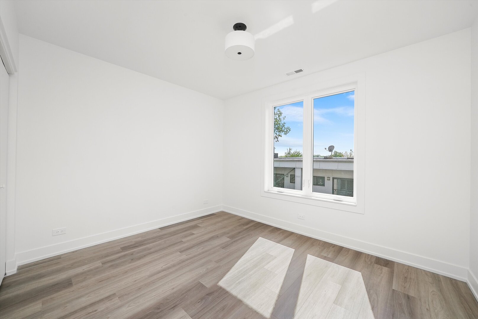 2030 Greenwood Street, Unit 206 Evanston, IL 60201 - Photo 22 of 27 a view of a bedroom with wooden floor and windows