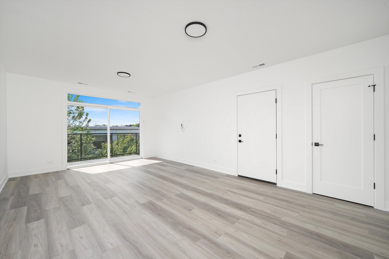 2030 Greenwood Street, Unit 206 Evanston, IL 60201 - Photo 8 of 27 a view of an empty room with wooden floor and a window