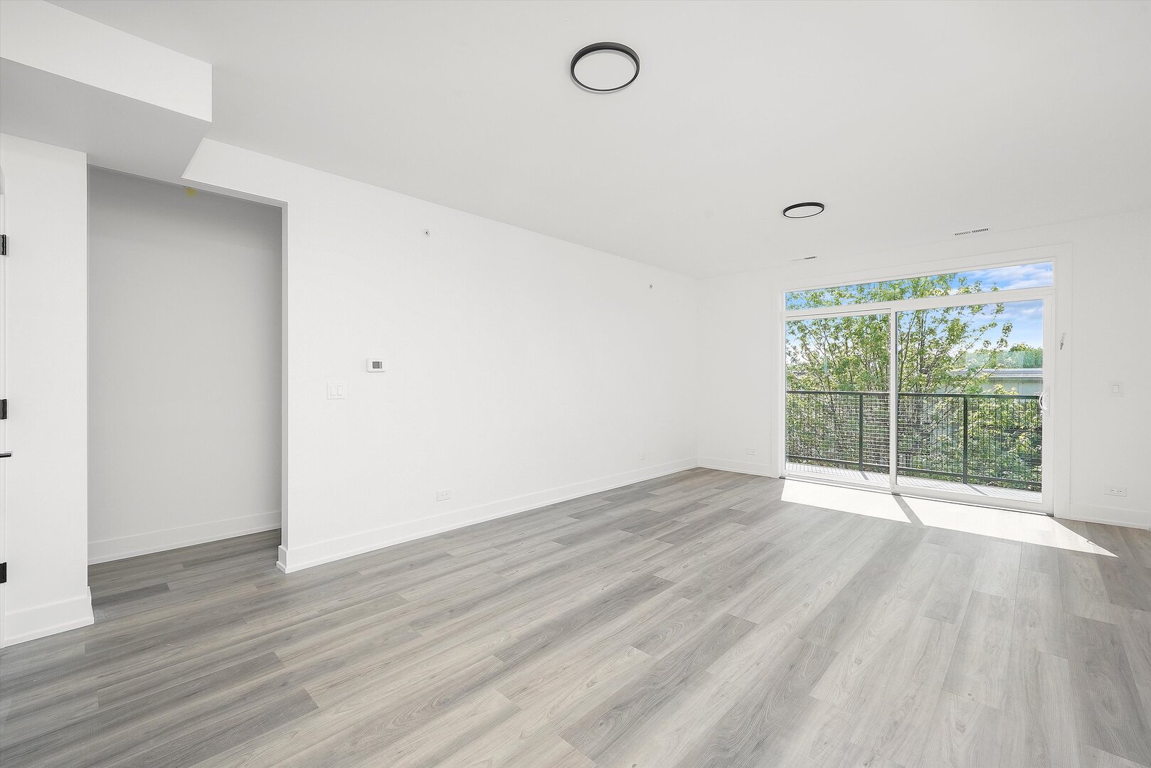 2030 Greenwood Street, Unit 206 Evanston, IL 60201 - Photo 10 of 27 wooden floor in an empty room with a window