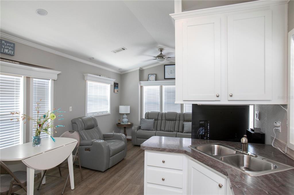 5642 Oak Ridge Avenue New Port Richey, FL 34652 - Photo 11 of 44 a kitchen with granite countertop a sink and a stove top oven with wooden floor